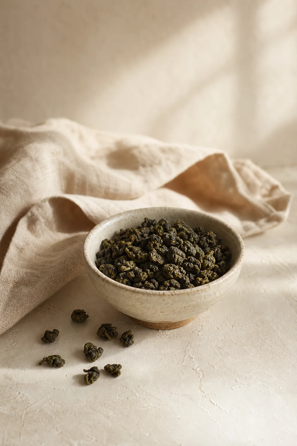 Rolled Misty Mountain Oolong leaves in a handmade stoneware bowl.